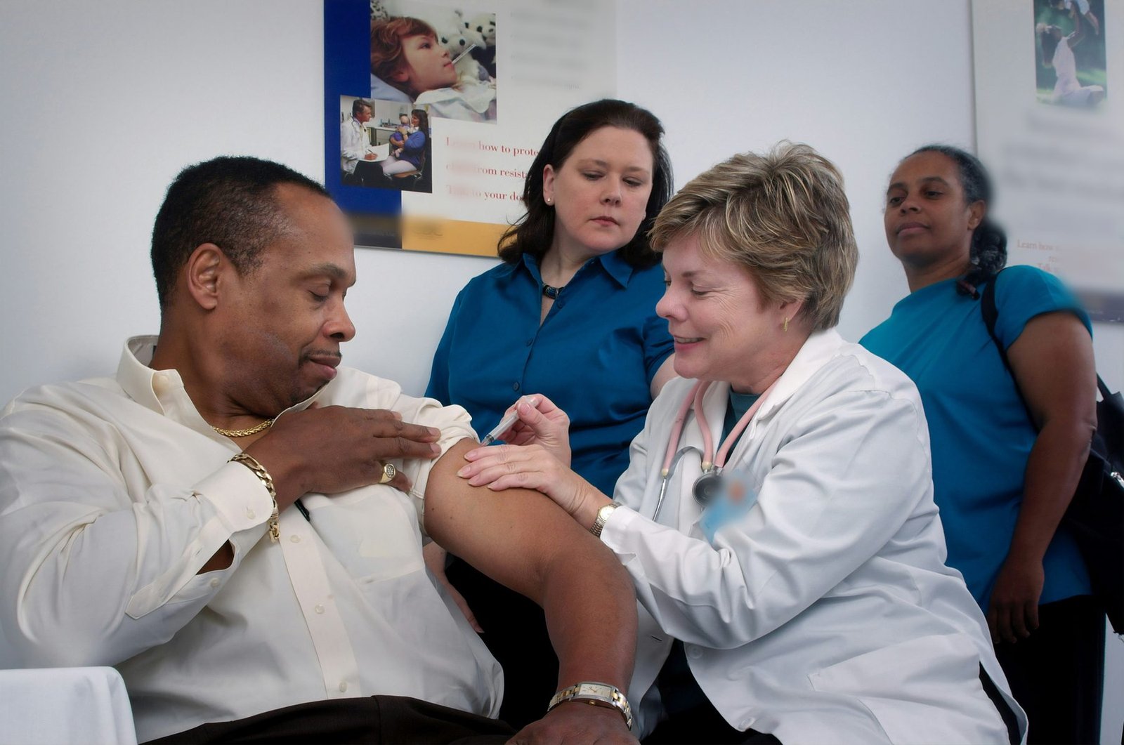 A clinician with patients during a consultation