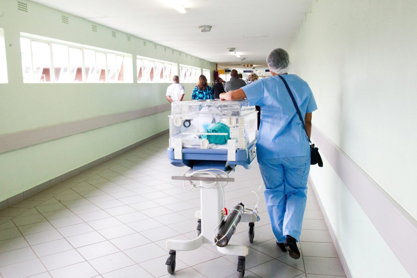 Clinical staff moving through a hospital corridor