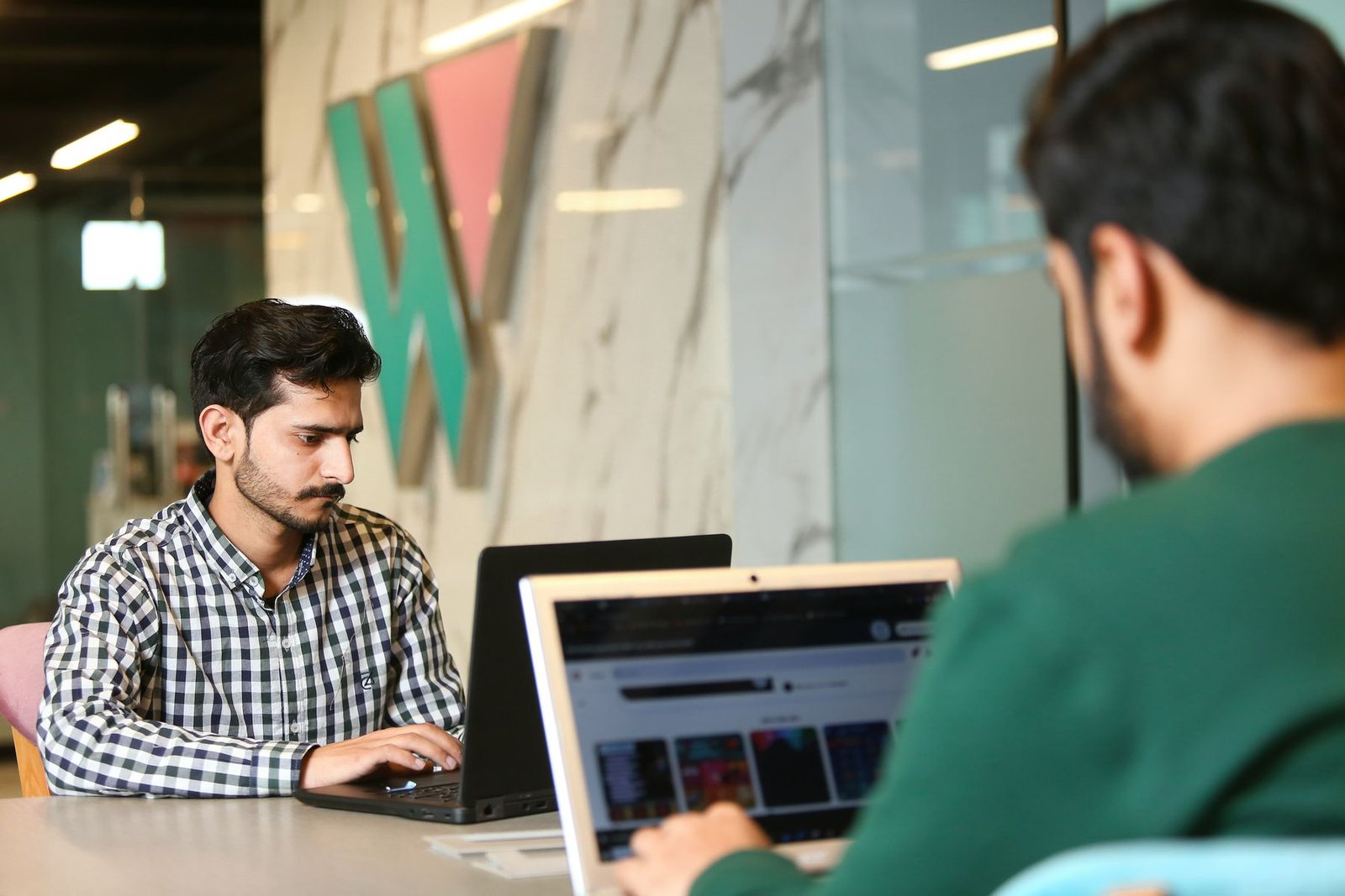 A person at a laptop working through a list